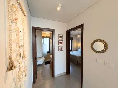 a room with a bathroom with a bed and a mirror at Panoramic Seaview Somabay 1BR Apartment in Mesca in Hurghada