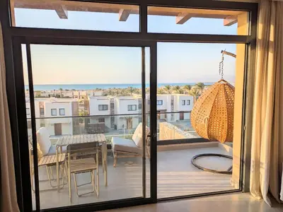 a view of a balcony with a table and chairs at Panoramic Seaview Somabay 1BR Apartment in Mesca in Hurghada