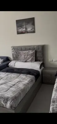 a bedroom with a bed and a picture on the wall at غرفه فندقيه in Hurghada