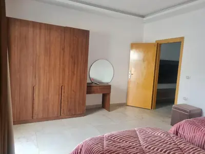 a bedroom with a bed and a dresser and a mirror at Mirage Bay Resort & Aqua Park in Hurghada