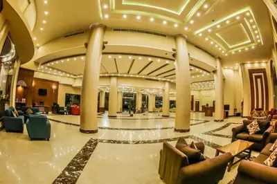 a lobby with couches and chairs in a building at Mirage Bay Resort & Aqua Park in Hurghada