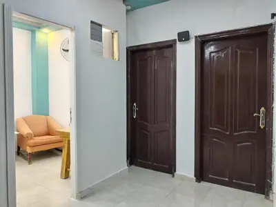 two brown doors in a room with a chair at room 4 a room in Hostel of 4 rooms in Hurghada