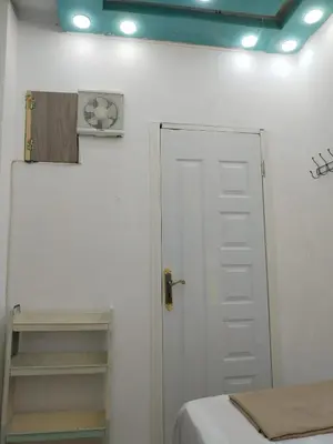 a room with a bed and a white door at room 4 a room in Hostel of 4 rooms in Hurghada