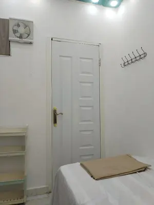 a bedroom with a white door with a towel on it at room 4 a room in Hostel of 4 rooms in Hurghada
