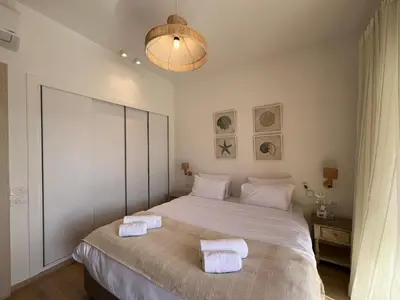 a bedroom with a large bed with towels on it at Gouna Ground-Floor Stylish 2Bdr in Hurghada