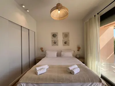 a bedroom with a large bed with towels on it at Gouna Ground-Floor Stylish 2Bdr in Hurghada