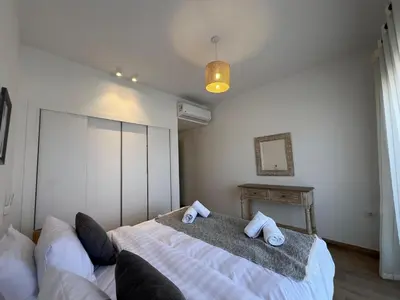 a bedroom with a bed with two towels on it at Gouna Ground-Floor Stylish 2Bdr in Hurghada