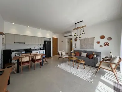 a kitchen and living room with a couch and a table at Gouna Ground-Floor Stylish 2Bdr in Hurghada