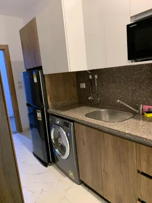 a kitchen with a washing machine and a sink at La prestigia Hurghada Apartment by Hurghada Concierge in Hurghada