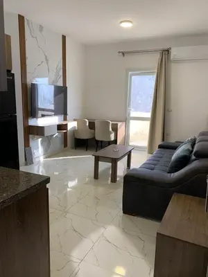 a living room with a couch and a tv at La prestigia Hurghada Apartment by Hurghada Concierge in Hurghada