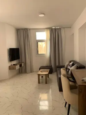a living room with a couch and a table at La prestigia Hurghada Apartment by Hurghada Concierge in Hurghada