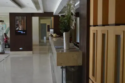 a lobby with a counter with a potted plant on it at Rivoli Suites in Hurghada