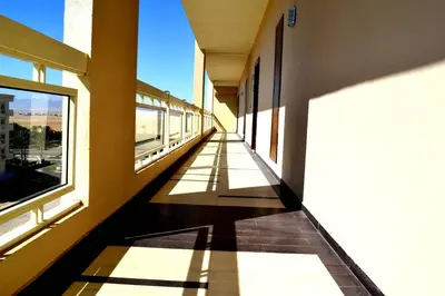 an empty hallway of a building with windows at Rivoli Suites in Hurghada
