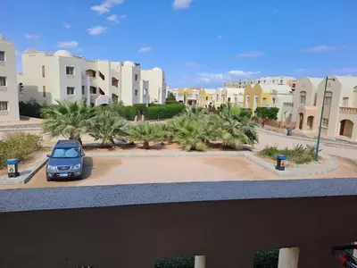 a car parked in a parking lot in front of buildings at 2BR Makadi heights -cozy Flat in Hurghada
