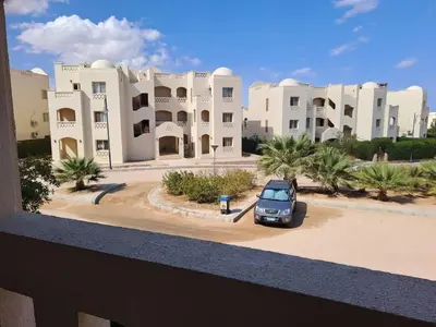 a car parked in a parking lot in front of a building at 2BR Makadi heights -cozy Flat in Hurghada