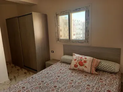 a bedroom with a bed and a window at hurghada , Elhegaz road in Hurghada