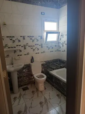 a bathroom with a toilet and a sink at hurghada , Elhegaz road in Hurghada