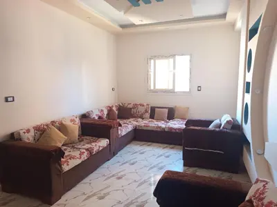 a living room with couches and a window at hurghada , Elhegaz road in Hurghada