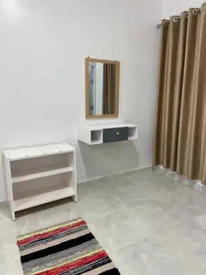 a dressing room with a mirror and a rug at OBAI Nubian Guest House in Aswan