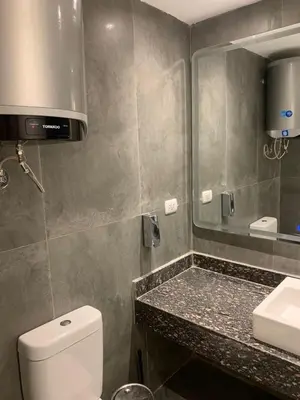 a bathroom with a toilet and a sink and a mirror at Bali - Elgouna Two Bedrooms private Heated pool in Hurghada