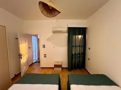a room with two beds and a room with a window at Beautiful desert, mountains, Hurghada skyline view in Hurghada