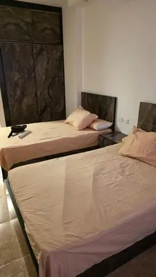 two beds sitting next to each other in a room at florenza-50 in Hurghada