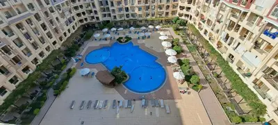 an aerial view of a swimming pool in a courtyard between two buildings at florenza-50 in Hurghada