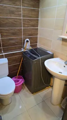 a bathroom with a trash can and a toilet and a sink at florenza-50 in Hurghada