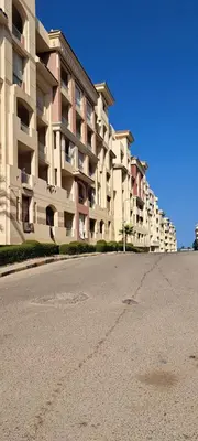 an empty street in front of a large building at florenza-50 in Hurghada