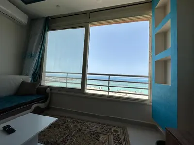 a room with a large window with a view of the ocean at كورنيش القيادات in Hurghada