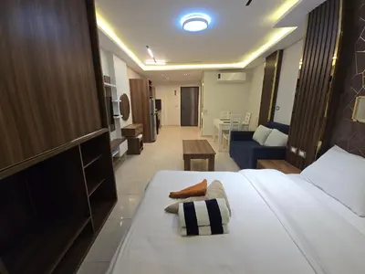 a bedroom with a bed and a living room at Dive Hostel Hurghada Tiba Golden in Hurghada
