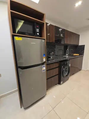 a kitchen with a refrigerator and a microwave at Dive Hostel Hurghada Tiba Golden in Hurghada