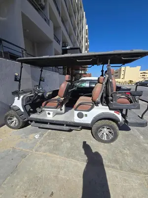 a shadow of a person standing next to a golf cart at Dive Hostel Hurghada Tiba Golden in Hurghada