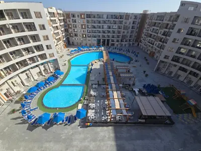an aerial view of an apartment complex with a swimming pool at Dive Hostel Hurghada Tiba Golden in Hurghada