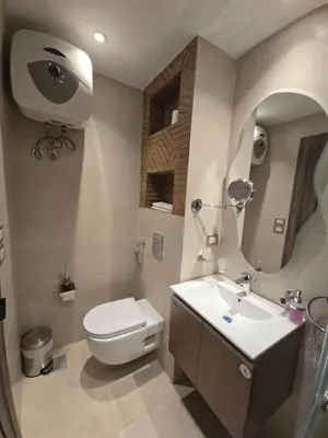 a bathroom with a toilet and a sink and a mirror at Dive Hostel Hurghada Tiba Golden in Hurghada