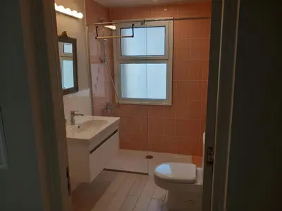 a bathroom with a sink and a toilet and a window at Modern Marina View 2 beds apt -New Marina-El Gouna in Hurghada