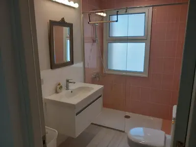 a bathroom with a sink and a toilet and a window at Modern Marina View 2 beds apt -New Marina-El Gouna in Hurghada