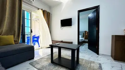 a living room with a couch and a table and a mirror at LA MERA Suite in Hurghada