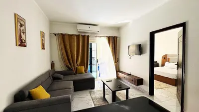 a living room with a couch and a mirror at LA MERA Suite in Hurghada