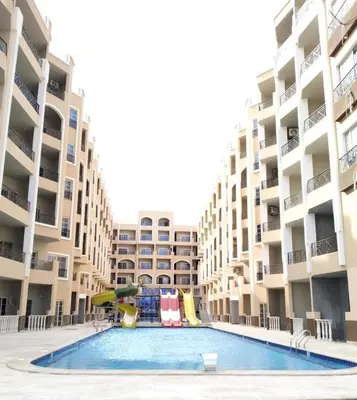 a swimming pool in the middle of a apartment complex at LA MERA Suite in Hurghada