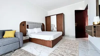 a bedroom with a bed and a couch at LA MERA Suite in Hurghada