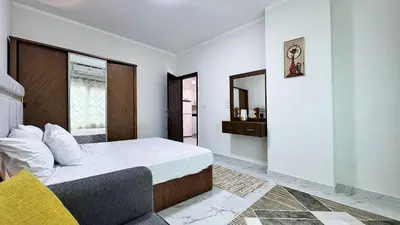 a bedroom with a large bed and a mirror at LA MERA Suite in Hurghada