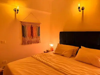 a bedroom with a large bed with two pillows at Boho 2-BDR Haven in Makadi Heights - By Kemetland in Hurghada