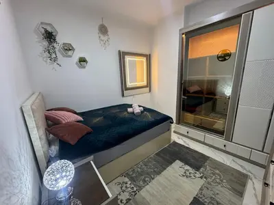 a small bedroom with a bed and a mirror at Turtles Beach Resort Al-Ahyaa in Hurghada