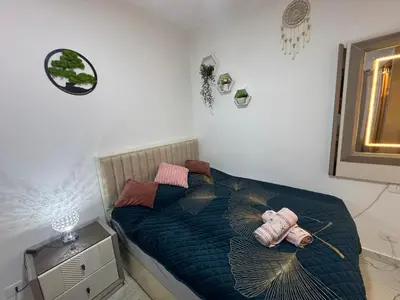 a bedroom with a bed with a blue comforter and two pillows at Turtles Beach Resort Al-Ahyaa in Hurghada