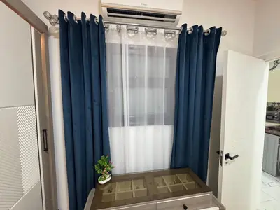 a window with blue curtains in a room at Turtles Beach Resort Al-Ahyaa in Hurghada