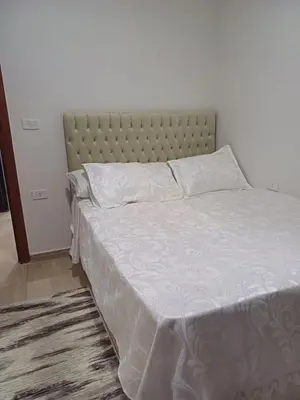 a bedroom with a bed with a large white bedspread at Appartement for rent in Hurghada in Hurghada