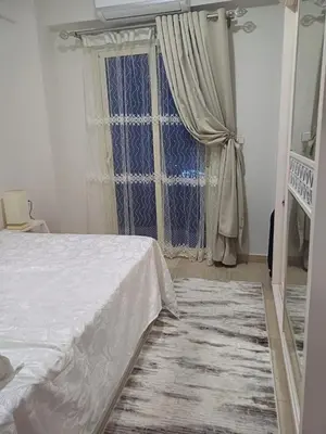 a bedroom with a white bed and a window at Appartement for rent in Hurghada in Hurghada