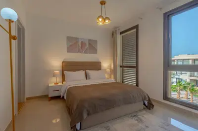 a bedroom with a bed and a large window at 2-Bedroom Penthouse in G-Cribs Gouna in Hurghada