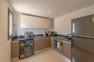 a kitchen with a washing machine and a washer at 2-Bedroom Penthouse in G-Cribs Gouna in Hurghada